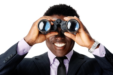 confident young black businessman looking through his binoculars at what the future business vision isの写真素材