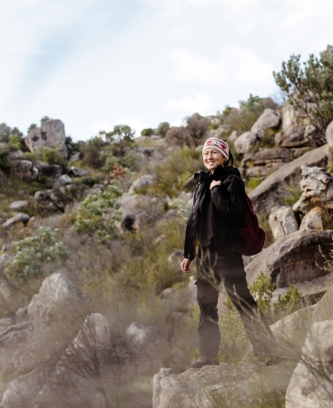 happy carefree hiker trekking asian woman outdoors with backpack walking in the wilderness and nature. adventure exploration touristの写真素材