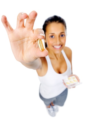 Healthy heart woman with omega 3 capsule to show a balanced diet and good cardiovascular healthの写真素材