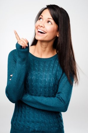 cheerful woman thinking and looking up with high aspirationsの写真素材
