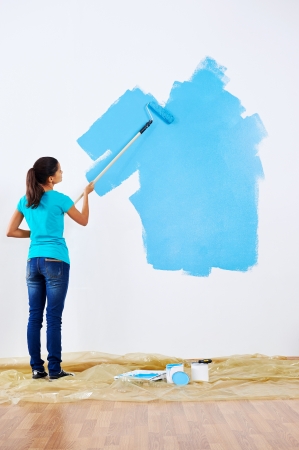 woman painting wall in new homeの写真素材
