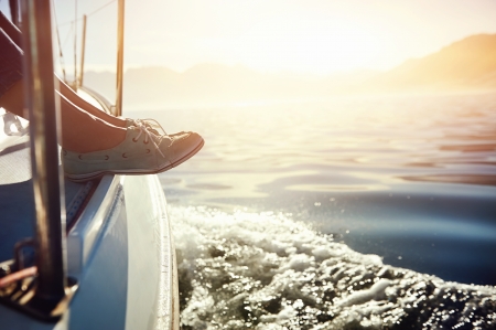 feet on boat sailing at sunrise lifestyle feet on boat sailing at sunrise lifestyle