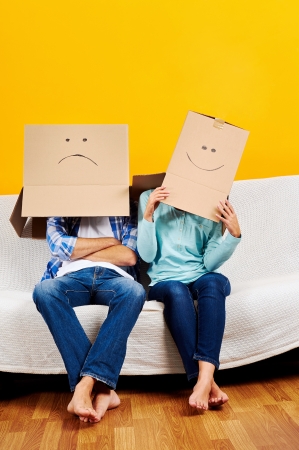 couple with empty box on head moving into new home fun gameの写真素材