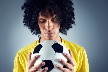 Portrait of Brazilian soccer football player with ball and national kit  の写真素材
