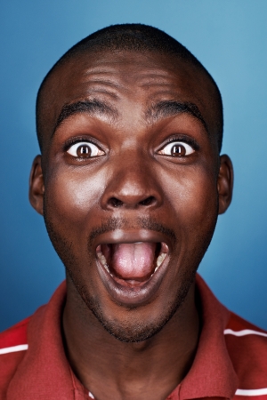 portrait of funny face real african man screaming faceの写真素材