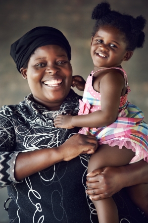 Rural African mother and baby girl smiling and having fun togetherの写真素材