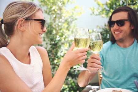 Couple drinking white wine at lunch while on summer vacation