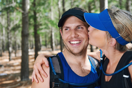 Healthy active couple kiss portrait in fitness gearの写真素材