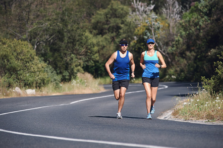 Couple training together for marathon on road run
