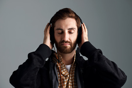 Man listening to music relaxing and enjoying good sound quality on professional dj headphones