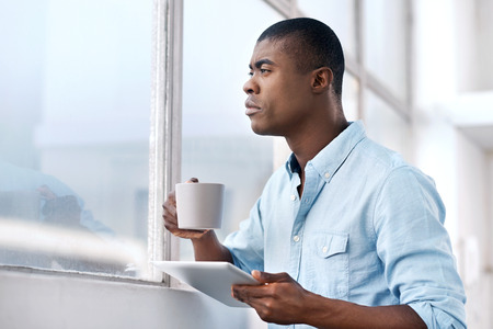 black african businessman with tablet and coffee