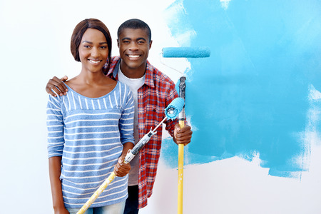 Fresh coat of paint on new apartment for young black african couple who have success and a homeの写真素材