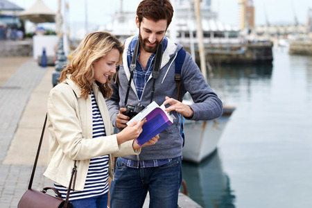 tourist couple with guide book on vacationの写真素材