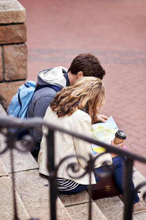 couple with map looking for directions in new city on vacation