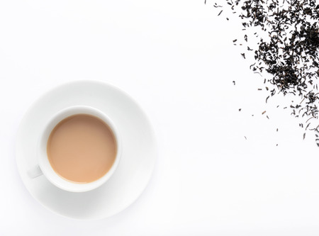 Hot milky tea with tea leaves, overhead view with plenty of copy spaceの写真素材
