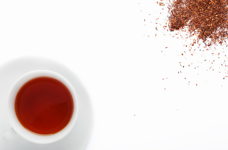 Cup of south african rooibos tea, healthy non caffeine detoxing drink with loose scattered leavesの写真素材