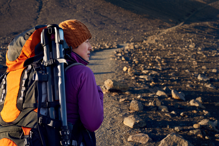 Young asian woman hiking in Iceland with backpack and outdoor gear on vacation holiday travel...
