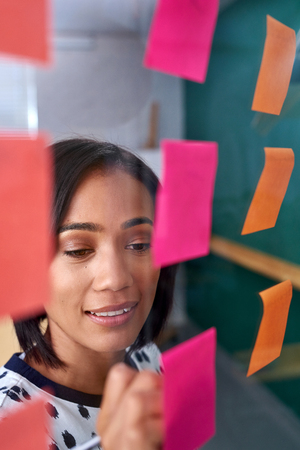 mixed race business woman brainstorming in modern office boardroom meetingの写真素材