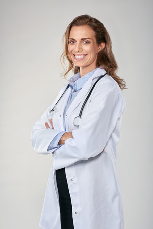 Happy woman female doctor with stethoscope, medical healthcare concept isolated in studioの写真素材