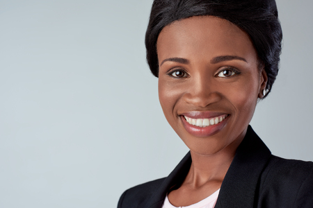 smiling portrait of a beautiful black african woman in studioの写真素材