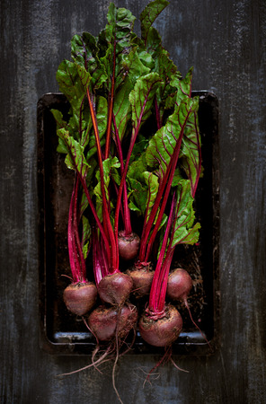 Bunch of raw fresh beetroots on a dark rustic background, plenty of copy spaceの写真素材