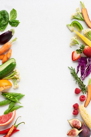 Fresh produce background side border of organic produce colourful fruit and veg, carrot chilli cucumber purple cabbage spinach rosemary herb, posterの写真素材
