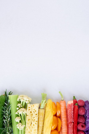 colorful food background, frame border of rainbow spectrum gradient of organic fresh fruit and vegetables