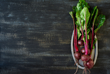 Bunch of raw fresh beetroots on a dark rustic background, plenty of copy spaceの写真素材