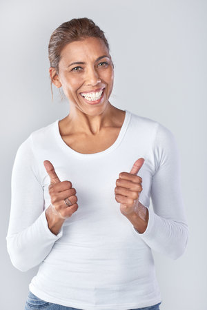 Portrait of asian woman with two thumbs up, happy approvalの写真素材