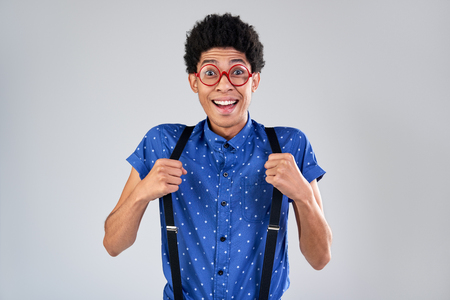 Funny mixed race man comedian portrait with excited shocked faceの写真素材