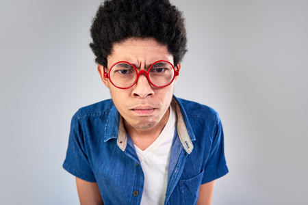 Man angry unhappy upset creasing his forehead disappointed in studioの写真素材