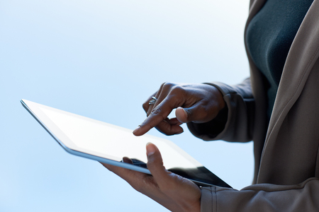 Modern business woman  using a tablet computer using apps application accessing online contentの写真素材