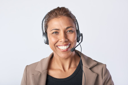 Portrait of latino woman with headphones Consulting and assistance service call centerの写真素材