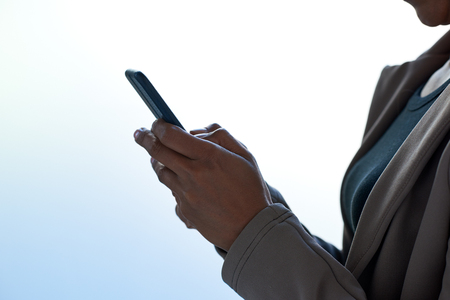 Modern business woman  using a smartphone using apps application accessing online contentの写真素材