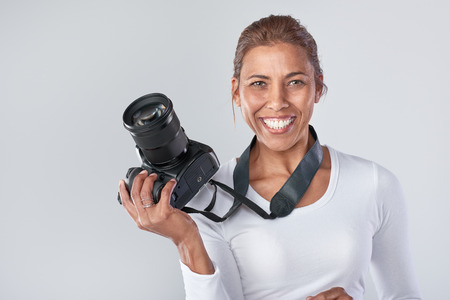 Confident woman holding dslr camera, professional photographerの写真素材