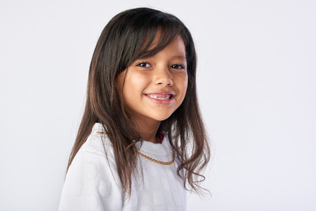 cute young child portrait in studio isolated on white backgroundの写真素材