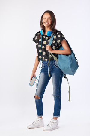 Happy mixed race hispanic asian woman student going back to school universityの写真素材