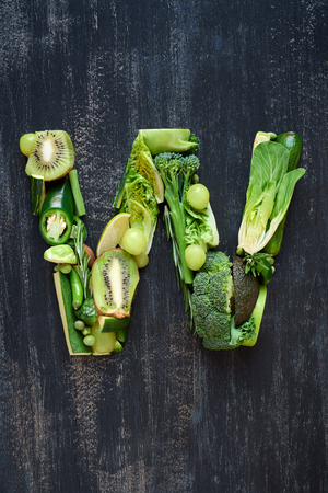 Flat lay series of healthy green produce fruit and vegetables shaped into letters of alphabet, design element poster spelling layoutの写真素材