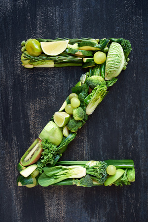 Flat lay series of healthy green produce fruit and vegetables shaped into letters of alphabet, design element poster spelling layoutの写真素材