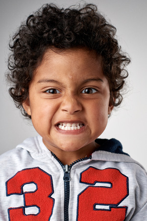 Young boy making silly face portrait in studioの写真素材