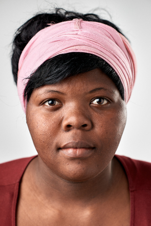 Portrait of real black african woman with no expression ID or passport photo full collection of diverse face and expressionsの写真素材