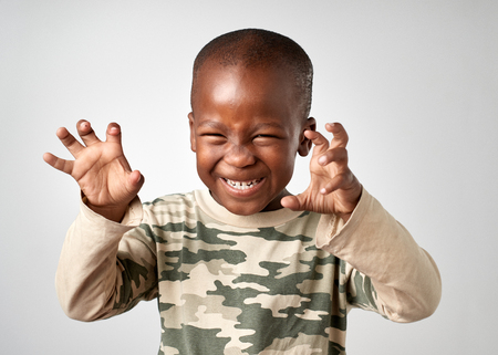 Young boy making silly face portrait in studioの写真素材