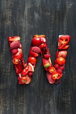 Vegetable letters formed from red fruits produce, overhead flatlay seriesの写真素材