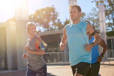 Running friends exercising together in the morning, summer sunlight healthy lifestyleの写真素材