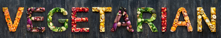 Flat lay collection of food words formed by fresh produce fruits and vegetables raw harvestの写真素材