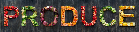 Flat lay collection of food words formed by fresh produce fruits and vegetables raw harvestの写真素材