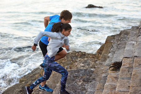 Sunrise workout fitness regime, couple training on beach outdoor active lifestyleの写真素材