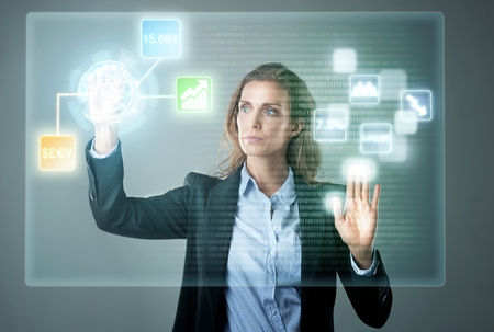 Business woman using finance trading digital hologram display for work, analysing business information forex dataの写真素材