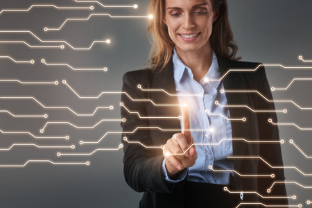 Businessperson touching hi-tech holographic interface digital display of connections, modern technologyの写真素材