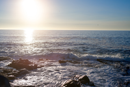 Sun setting on horizon, peaceful background travel aspirationの写真素材